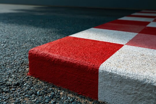 Painted curbstone corner with red and white checker stripes for motorsport banner and trackside background design