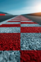 Fototapeta premium Low angle racetrack checkerboard curb with red and white squares leading into horizon for racing wallpaper and banner use, shallow depth of field and dramatic perspective