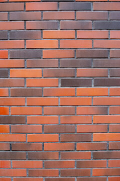 Modern smooth red and brown clinker brick wall vertical texture