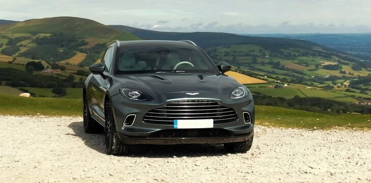 Aston Martin DBX, English luxury SUV. driving in the mountains