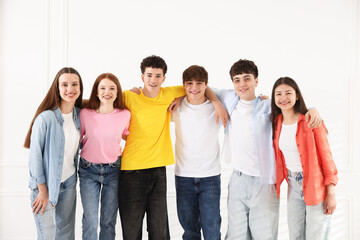 Obraz premium Portrait of happy teenagers near white wall indoors
