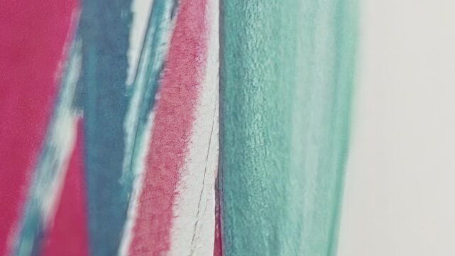 A macro view reveals the textured, colorful bristles of a toothbrush, featuring vibrant pink, blue, and teal stripes.