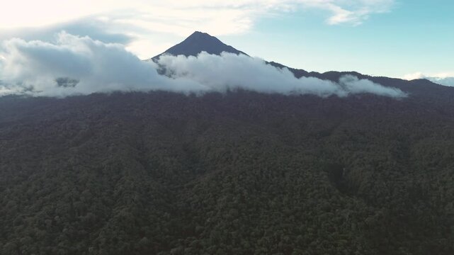 Drone View of Ecuador Volcano Rising Above Cloud Forest, Low Clouds, Green Mountain Slopes and Scenic Tropical Andean Wilderness Landscape