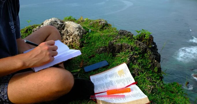 Man Studying the Bible on an Ocean Cliff in Bali, Indonesia | Peaceful Christian Devotional in Nature