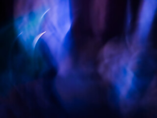 Fototapeta premium Abstract blurred background with dynamic sweeping light trails in vibrant purple, blue, and teal hues, conveying motion, energy, and a futuristic cosmic atmosphere