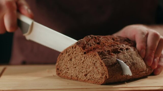 Black rye bread close up, cutting with knife dark brown sliced loaf, borodinsky slavic food, square slices with coriander on white background, baker with tasty healthy fresh bread.
