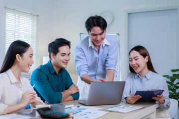 Fototapeta premium Asian business team collaborating on financial project using laptop
