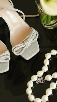 Vertical video. Wedding accessories with bridal shoes, pearls and calla lilies for the bride's morning.