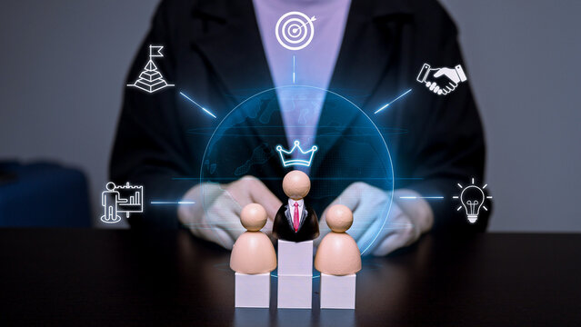 Business leader wooden doll on a podium with digital corporate goal and success icons overlay, representing leadership, team management, and human resources strategy.