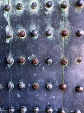 Weathered studded metal gate of a Japanese castle