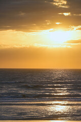 Fototapeta premium Golden clouds at Zandvoort during sunset, with soft warm tones and textured sky gradients ideal for calm atmospheric designs.