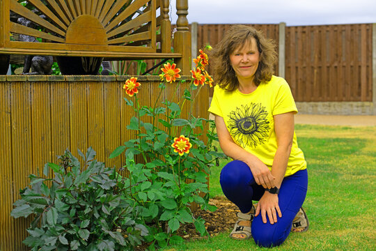 Portrait with Pooh Dahlias, in July, 2026.