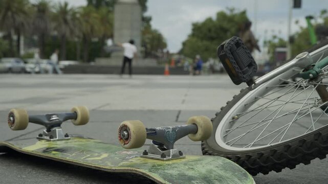 Skateboard and Wheels In Foreground Ground-Level Plaza