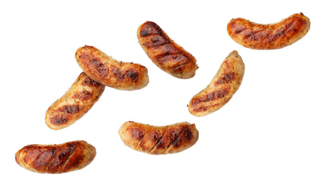 Delicious grilled sausages flying in air on white background
