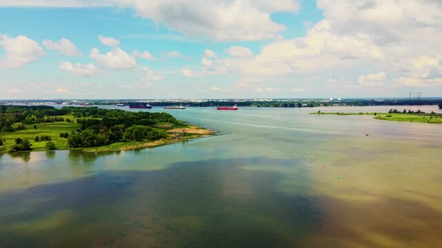 Boucherville, Canada - June 22 2026: A spectacular 4K aerial sweep over the Saint Lawrence River near Boucherville, capturing serene island channels, lush green coastlines