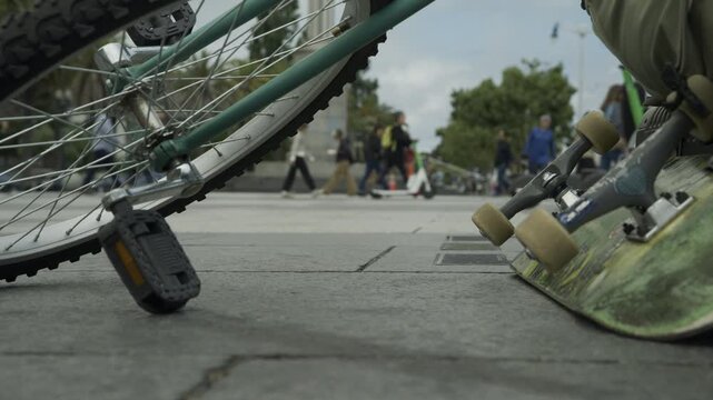 BMX Bike Wheel And Skateboard Ground Level Close-Up In San Francisco Plaza