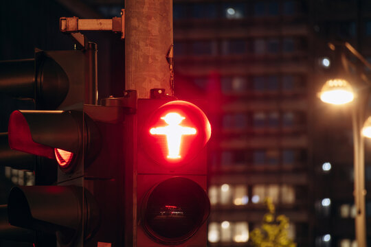 Berlin, Germany - April 22, 2026: Red Ampelmann pedestrian traffic signal illuminated at night in central Berlin