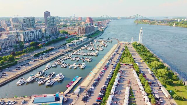 Montreal, Canada - June 29 2026: A spectacular 4K aerial sweep over Montreal's historic Old Port, capturing the expansive waterfront scenery, scenic promenades, and urban skyline
