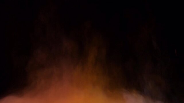 Abstract Glowing Orange Fire Light Effects on Black Background.