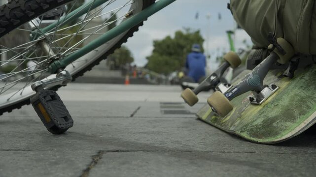 Skateboard and Wheels In Low, Extreme Close-Up With People In Background