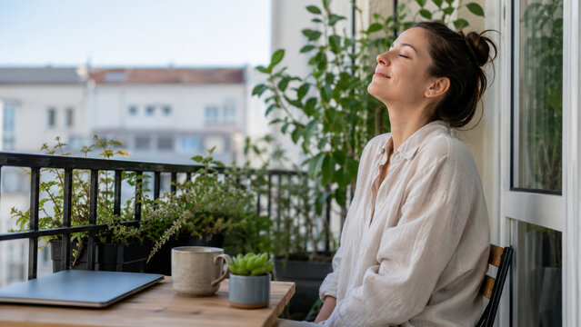 Remote worker taking a peaceful breathing break on a balcony
