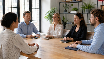 Fototapeta premium Office team taking a mindful pause during a quiet workday