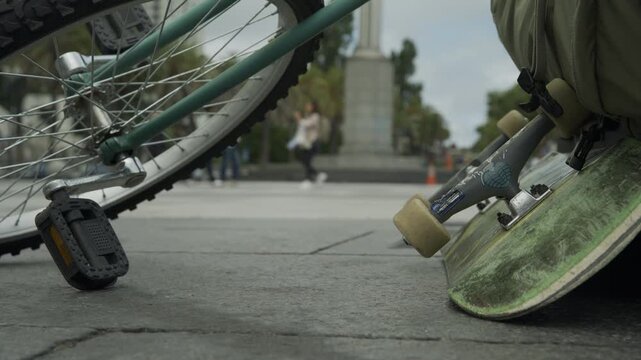 Skateboard Deck Underside and Bicycle Pedal - Extreme Close-Up In San Francisco Plaza