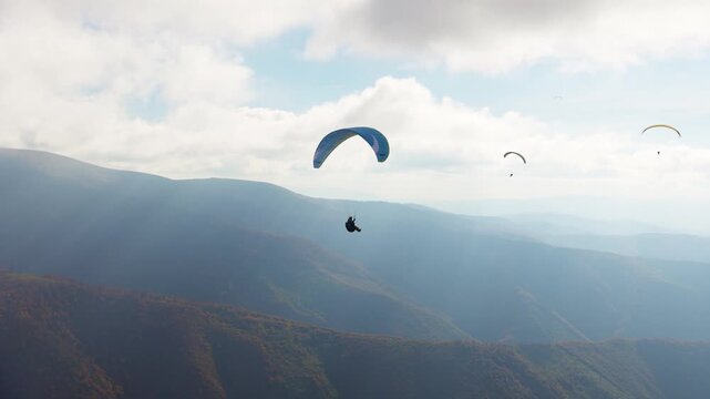 Paragliding active sport against giant mountains in highland