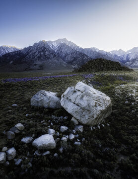 Aerial view of the Alabama Hills with large granite boulders and the snow-capped Sierra Nevada mountains in the background in Inyo County, California, United States.