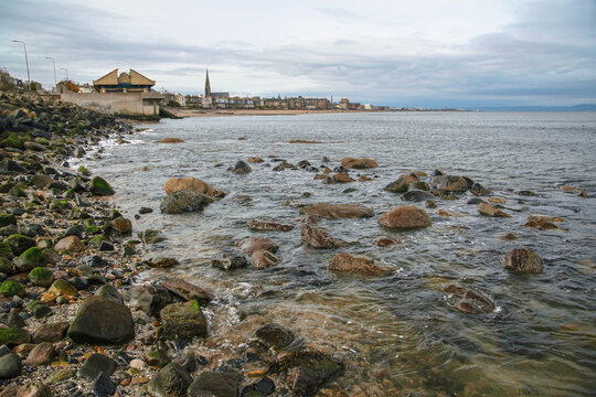 East end of Portobello beach in Edinburgh, overcast autumn day, Joppa parish church tower visible at distance