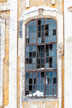 narrow window with broken glass panes in building