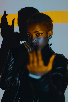 Woman Posing in a Colourful Lighting Setup Indoors