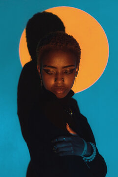 Woman Posing in a Colourful Lighting Setup Indoors