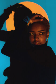 Woman Posing in a Colourful Lighting Setup Indoors