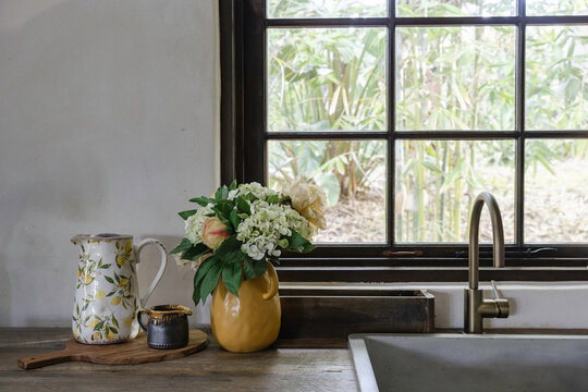 A rustic kitchen with farmhouse sink and open shelving