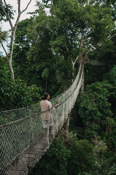Traveler Woman Exploring Nature in a Hanging Bridge 