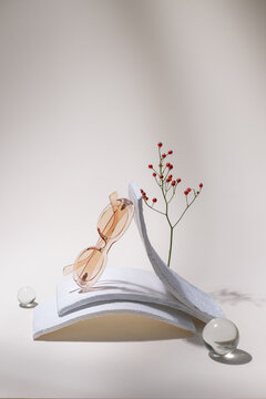 Elegant Sunglasses Displayed Among Artistic Elements