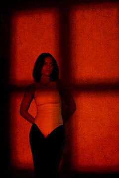 Woman under dramatic light beam