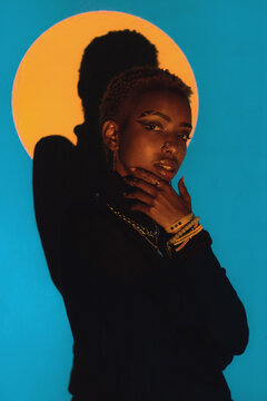Woman Posing in a Colourful Lighting Setup Indoors