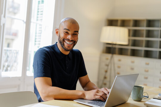 Man working remotely using laptop in office