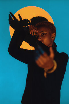 Woman Posing in a Colourful Lighting Setup Indoors