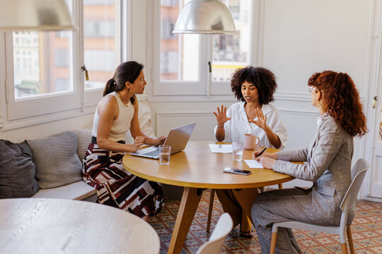 Female colleagues collaborating during a business planning meeting