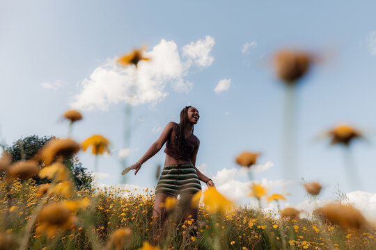 Confident Woman Dancing in a Field of Flowers