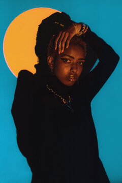 Woman Posing in a Colourful Lighting Setup Indoors