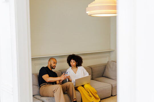 Partners sharing digital content on a mobile device and laptop