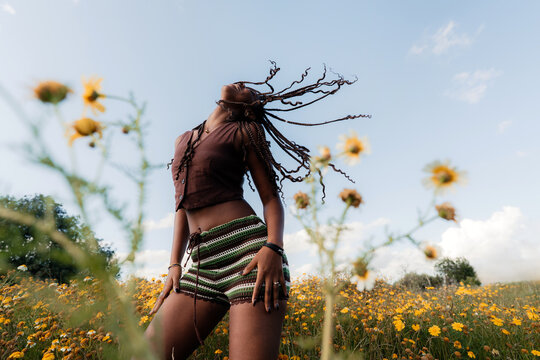 Confident Woman Dancing in a Field of Flowers