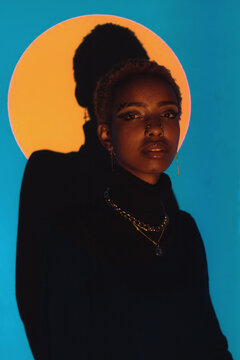 Woman Posing in a Colourful Lighting Setup Indoors
