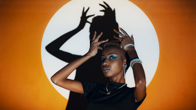 Woman Posing in a Colourful Lighting Setup Indoors