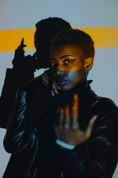 Woman Posing in a Colourful Lighting Setup Indoors