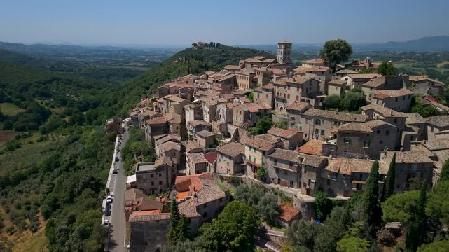 Casperia Rieti Italy.  aerial backward drone shot revealing circular hilltop borgo medieval stone houses historic village landscape, Lazio travel destination